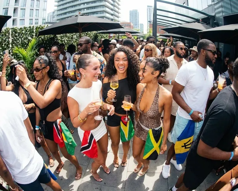 Soca Forever party crowd waving Trinidad, Guyana, Jamaica and Barbados flags