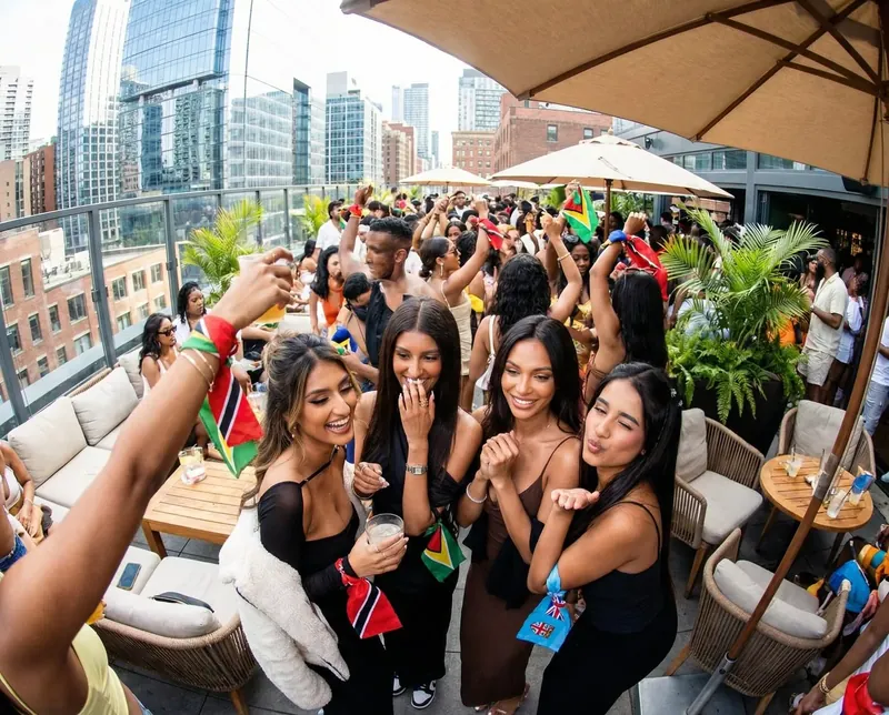 Soca Forever rooftop party with the Toronto downtown skyline behind the crowd